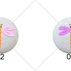 May include: Four round, white, ceramic cabochons with a dragonfly design. The dragonflies are in different colors: light blue, pink, purple, and green.