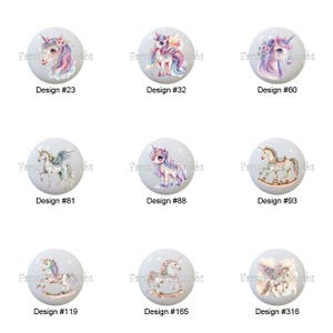 May include: Nine white cabinet knobs with unicorn designs. Each knob features a different unicorn illustration in pastel colors, with text labels indicating design numbers such as #23, #32, and #60. The knobs are round and have a glossy finish.