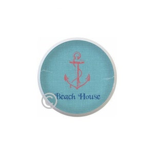 May include: A round, blue and white coaster with a red anchor and the text "Beach House" in blue.