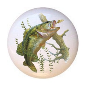 May include: A green and brown bass fish leaping out of the water with its mouth open, catching a smaller fish. The bass is surrounded by green aquatic plants and a brown tree branch.
