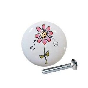 May include: Set of five white ceramic drawer knobs with spring-themed designs. The knobs feature a butterfly, dragonfly, flower, heart, and the word "Spring".