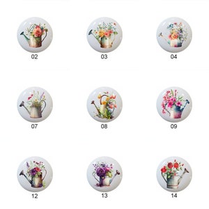 May include: Set of 14 round ceramic cabinet knobs with a white background and a watercolor design of a watering can filled with colorful flowers. The knobs are numbered 01 through 14.