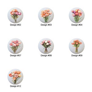 May include: Twelve different designs of round ceramic knobs featuring bouquets of pink, white, and purple tulips.
