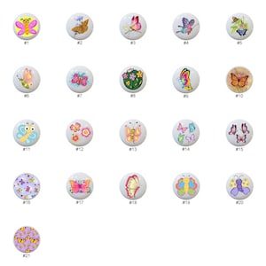 May include: Twenty-one ceramic knobs with butterfly designs. The knobs are white with various colorful butterfly designs, including pink, blue, yellow, and orange butterflies.