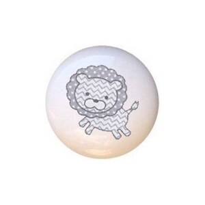 May include: Three white ceramic knobs with gray animal illustrations. The knobs feature a gray elephant, a gray lion, and a gray giraffe.