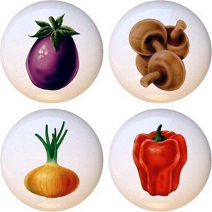 May include: Four ceramic knobs with painted images of vegetables and mushrooms. The knobs feature a purple eggplant, a yellow onion, a red bell pepper, and a group of brown mushrooms.