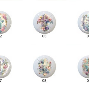 May include: Ten round ceramic tiles with a white background and a floral design featuring a cross in the center. The cross is surrounded by flowers in shades of pink, blue, and green.