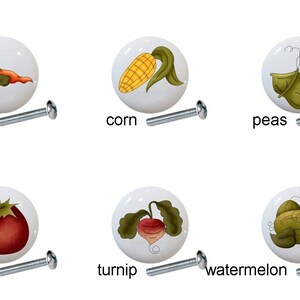 May include: Set of 10 ceramic cabinet knobs featuring various vegetables, including beans, carrots, corn, peas, potatoes, squash, tomatoes, turnips, watermelon. Each knob has a white background and a silver screw.
