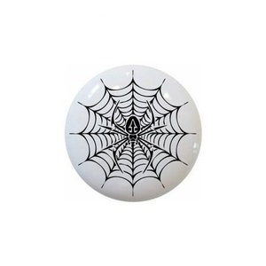 May include: White, round decorative knob featuring a black spider web design with a spider in the center. The knob is likely made of ceramic or porcelain and is suitable for furniture or cabinet doors.