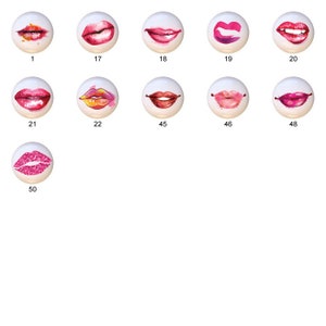 May include: A set of 10 round, white ceramic buttons with different watercolor lip designs. The buttons are approximately 1 inch in diameter.