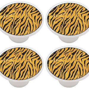 May include: Four round ceramic knobs with a tiger stripe pattern in black and orange.