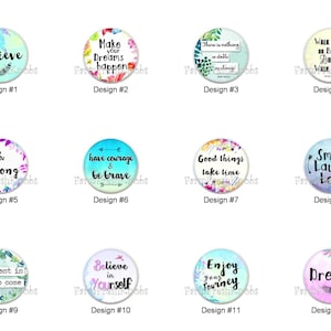 May include: A collection of twelve round, decorative buttons with inspirational quotes and floral or feather designs. Each button features a unique message in a stylish font, such as "Believe" or "Dream".