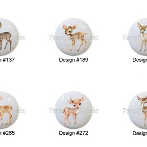 May include: Six white cabinet knobs with watercolor illustrations of deer. Each knob has a different deer design, with the design number printed below. The knobs are from Farmhouse Knobs.