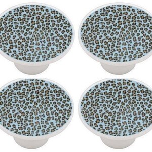 May include: Set of four ceramic cabinet knobs with a blue background and a brown leopard print pattern.