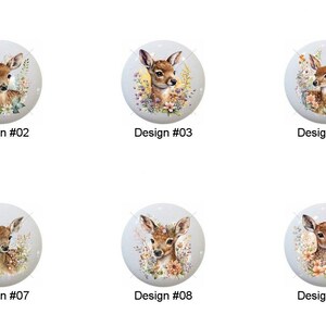 May include: A collection of ten round cabinet knobs, each featuring a watercolor illustration of a fawn. The knobs have a light blue background and are labeled with the design number. The fawn illustrations are surrounded by flowers.