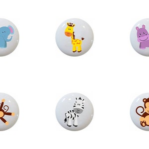 May include: Set of 10 ceramic knobs featuring various jungle animals, including a lion, zebra, monkey, giraffe, hippopotamus, elephant, and crocodile. The knobs are white with colorful animal illustrations.