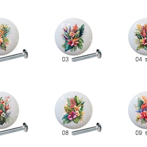 May include: Ten ceramic cabinet knobs with floral designs. Each knob features a different arrangement of tropical flowers and leaves in shades of pink, red, orange, yellow, green, and blue. The knobs are white with a glossy finish.