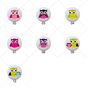 May include: Twelve different owl designs on white round ceramic tiles. The owls are in various colors, including orange, pink, blue, green, purple, and yellow. Some owls have their eyes closed, while others have their eyes open. Some owls are holding a smaller owl.
