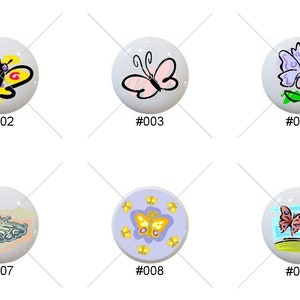 May include: Ten ceramic round knobs with various butterfly designs. The knobs are white with colorful butterfly illustrations. The designs include a yellow butterfly, a pink butterfly, a blue butterfly, a butterfly with a flower, a butterfly with a flower and a green leaf, a butterfly with a flower and a green leaf, a butterfly with a flower and a green leaf, a butterfly with a flower and a green leaf, a butterfly with a flower and a green leaf, and a butterfly with a flower and a green leaf.