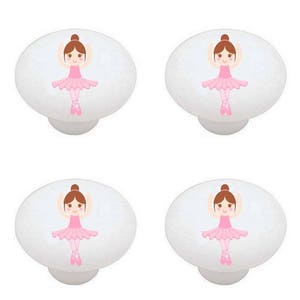 May include: Set of four white ceramic cabinet knobs with a ballerina design. Each knob features a pink ballerina with brown hair and a pink tutu.
