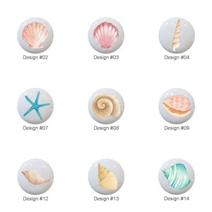 May include: A collection of fifteen decorative cabinet knobs, each featuring a different seashell design. The knobs are round and white, with various colors and patterns of seashells. Each knob is labeled with a design number.