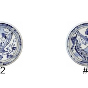 May include: Four blue and white ceramic plates with different designs. The first plate features a crown, the second plate features a floral design, the third plate features a wave design, and the fourth plate features a portrait of a woman.
