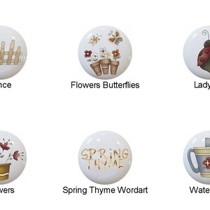 May include: Set of 10 ceramic knobs with spring-themed designs. The knobs feature images of a bear, fence, flowers, butterflies, ladybug, strawberry plant, bunny basket, flowers, a watering can, and a word art design that says "Spring Thyme".