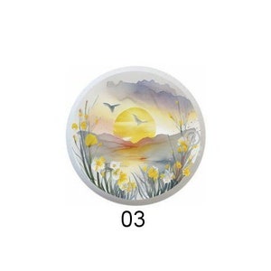 May include: Five round, colorful, ceramic plates with a sunset scene and daffodils. Each plate has a number from 1 to 5.