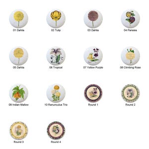 May include: A collection of decorative ceramic knobs featuring floral designs. Each knob has a white base with a different flower illustration, including dahlias, tulips, pansies, and climbing roses. Some knobs are round with floral patterns.