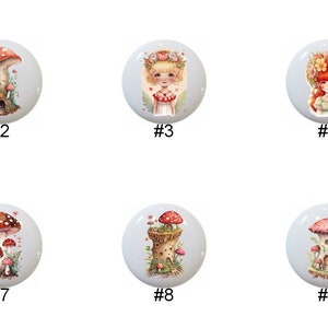 May include: Nine ceramic knobs with mushroom designs. The knobs feature various mushroom illustrations, including a mushroom house, a mushroom with a fairy, and a group of mushrooms.