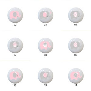 May include: Set of 14 gray and pink elephant themed ceramic knobs. Each knob features a different design with pink and gray stripes, polka dots, and chevron patterns.