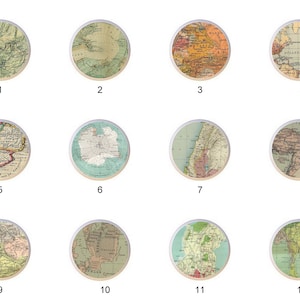 May include: Twelve vintage map designs on round white ceramic tiles. Each tile features a different map of a region of the world, including North America, South America, Europe, Asia, and Africa. The maps are in a vintage style with faded colors and detailed lines.