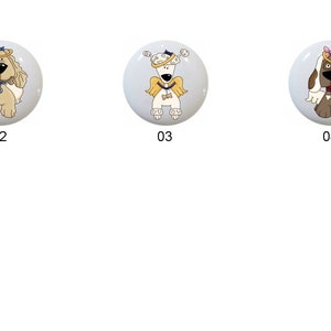 May include: Six ceramic knobs featuring different dog breeds wearing angel wings and halos. The knobs are white with a glossy finish. The dogs are brown, white, and black.