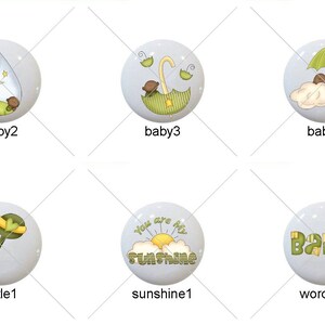 May include: Set of 10 baby shower themed ceramic tiles with various designs, including a baby boy, a giraffe, a rattle, a baby under an umbrella, a border of yellow stars, and a sun with the text "You are my sunshine".