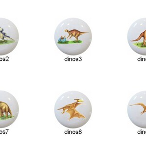 May include: Ten ceramic knobs featuring different dinosaur illustrations. The knobs are white with a glossy finish. The dinosaurs are depicted in various poses and colors, including green, brown, orange, and blue.