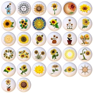 May include: A collection of white ceramic cabinet knobs, each featuring a unique sunflower design. The knobs showcase various artistic interpretations of sunflowers, including watercolor, cartoon, and stylized illustrations. The designs incorporate yellow, brown, and green hues.