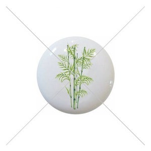 May include: A white ceramic knob with a green bamboo plant illustration.