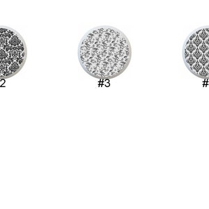 May include: Six different black and white patterned designs on round white coasters. The patterns include floral, geometric, and damask.