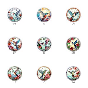 May include: A set of 14 stained glass round ornaments featuring hummingbirds in flight with floral designs. The ornaments are numbered 1 through 14.