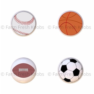 May include: Four different sports ball designs on white ceramic knobs. The designs are a baseball, basketball, football, and soccer ball.