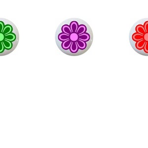 May include: Six round buttons with a flower design in different colors: blue, green, purple, red, teal, and yellow.