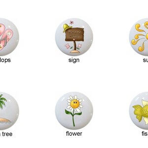 May include: Ten ceramic knobs with various summer-themed designs, including a fish, flip flops, a sign, the sun, a whale, a glass of lemonade, a palm tree, a flower, and two more fish.