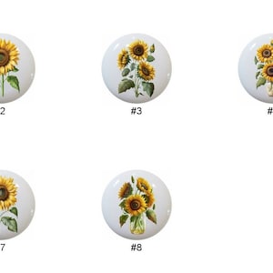 May include: Eight ceramic knobs with sunflower designs. The knobs feature sunflowers in baskets, vases, and single stems.