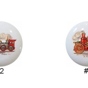 May include: Four ceramic knobs with vintage illustrations of steam-powered vehicles. The knobs are white with a glossy finish. The first knob features a red and black steam locomotive with a plume of smoke. The second knob features a red and black steam locomotive with a plume of smoke. The third knob features a red steam-powered tractor with a plume of smoke. The fourth knob features a red steam-powered tractor with a plume of smoke.