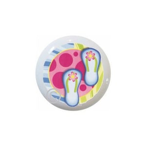 May include: A white ceramic knob with a colorful design of pink polka dots, blue and green stripes, and two blue flip flops with pink flowers.