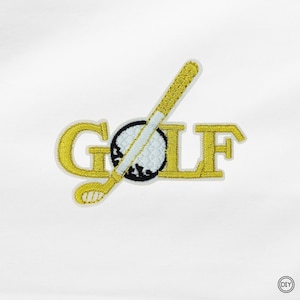 Könnte beinhalten: Gestickter Aufnäher mit dem Wort "GOLF" in Goldfaden, einem Golfball und einem Golfschläger-Design. Der Golfschläger ist weiß und goldfarben. Der Aufnäher befindet sich auf weißem Hintergrund.
