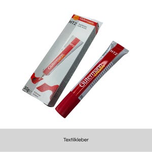 Könnte beinhalten: Eine Tube Textilkleber Gütermann HT2 mit rot-weißem Design und passender Schachtel. Tube und Schachtel zeigen das Gütermann-Logo und den Text "HT2". Die Tube enthält 30g Kleber.