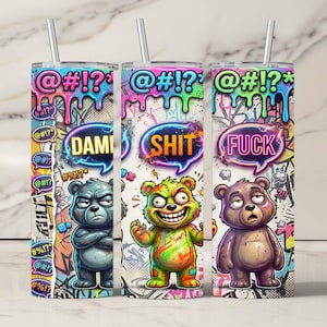 May include: Three stainless steel tumblers with cartoon bear designs. Each tumbler features a different bear with a speech bubble containing a curse word. The tumblers have a graffiti-style background and a straw.