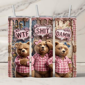 May include: Three stainless steel tumblers with straws, each featuring a cartoon bear in a pink plaid shirt. The bears have speech bubbles with the words "WTF," "SHIT," and "DAMN." The background has a distressed, vintage aesthetic.