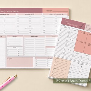 May include: A horizontal weekly brain dump planner pad and a vertical daily brain dump planner pad in shades of dusty rose and white. The horizontal pad features sections for early week, mid week, and weekend, while the vertical pad includes a daily schedule, to-do lists, and a four-quadrant priority matrix. A light pink pen is positioned in the lower left corner.